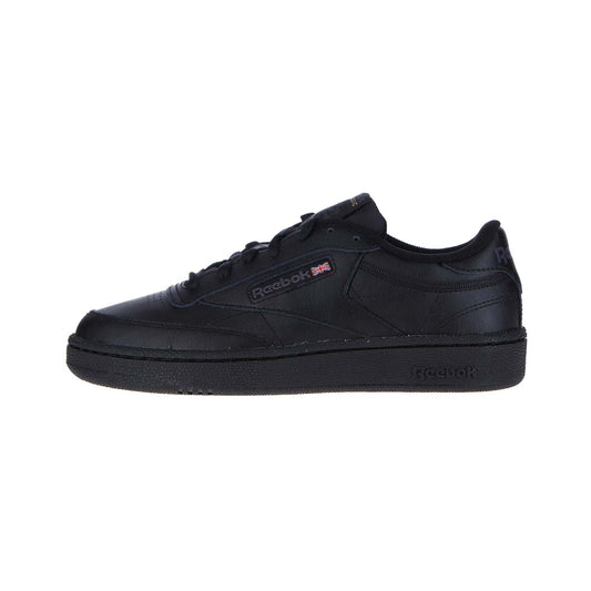 Der Reebok CLUB C 85 WMN/MN Sneaker in Int-Black/Charcoal hat ein Low-Top-Design, hochwertiges Leder, farblich abgestimmte Nähte, eine strukturierte Sohle, ein Reebok-Logo mit britischer Flagge an der Seite und ist auf einem weißen Hintergrund abgebildet.