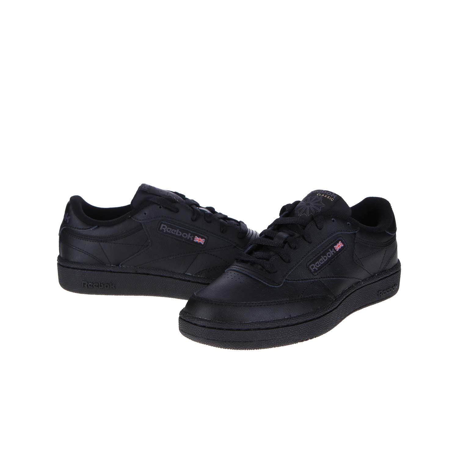 Die Reebok CLUB C 85 WMN/MN Sneakers in Schwarz und Anthrazit sind aus hochwertigem Leder, haben ein Low-Top-Design, das Reebok-Logo mit einem kleinen Union Jack an der Seite, schwarze Schnürsenkel und eine strukturierte Gummisohle für einen von Mailand inspirierten Stil.