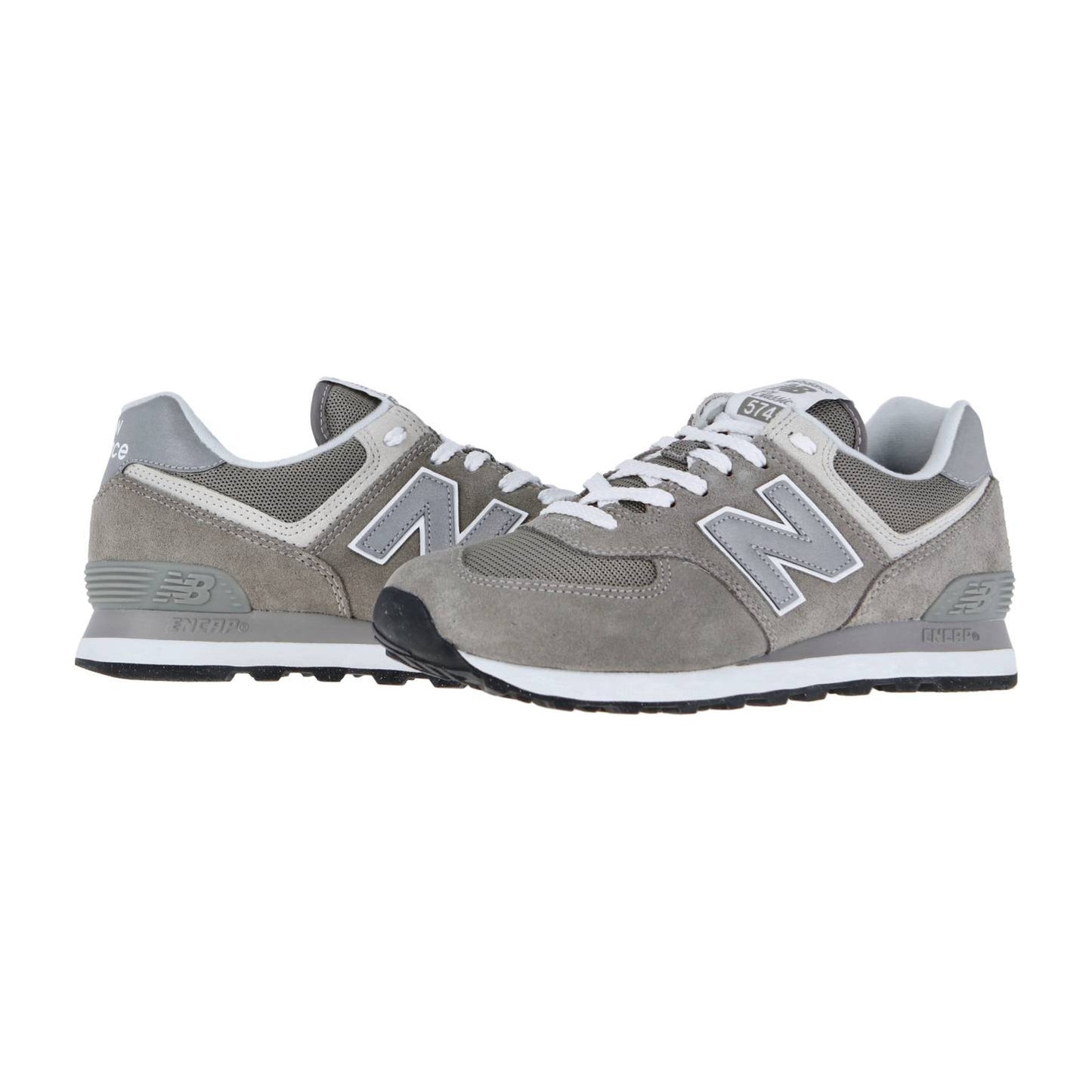 Die New Balance ML574V3 Retro-Sneaker haben ein graues Obermaterial aus Mesh und Wildleder, weiße Schnürsenkel, ein charakteristisches N-Logo an der Seite und die ENCAP-Technologie für Komfort und Unterstützung, dargestellt auf weißem Hintergrund.