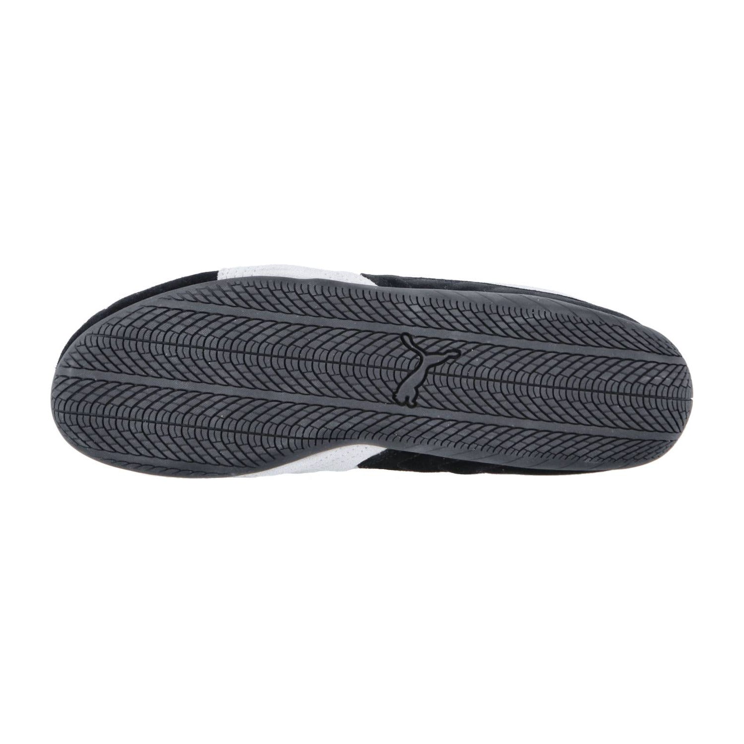 Das Bild zeigt die Sohle des Speedcat OG von Puma, ein schwarzer Motorsport-Sneaker mit einem strukturierten, gewellten Profil und einem kleinen Vogel-Logo in der Mitte, das den Racing-Lifestyle-Geist verkörpert.