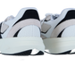Ein Paar Adidas LIGHTBLAZE Sneaker für Männer in Weiß mit schwarzen und beigen Akzenten, mit einer LIGHTSTRIKE Zwischensohle, die von hinten auf einem weißen Hintergrund dargestellt wird.