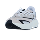 Der Adidas LIGHTBLAZE Sneaker Damen in Beige und Weiß mit schwarzen Akzenten verfügt über eine dicke weiße LIGHTSTRIKE Zwischensohle und weiße Schnürsenkel, die von vorne vor einem schlichten weißen Hintergrund gezeigt werden.