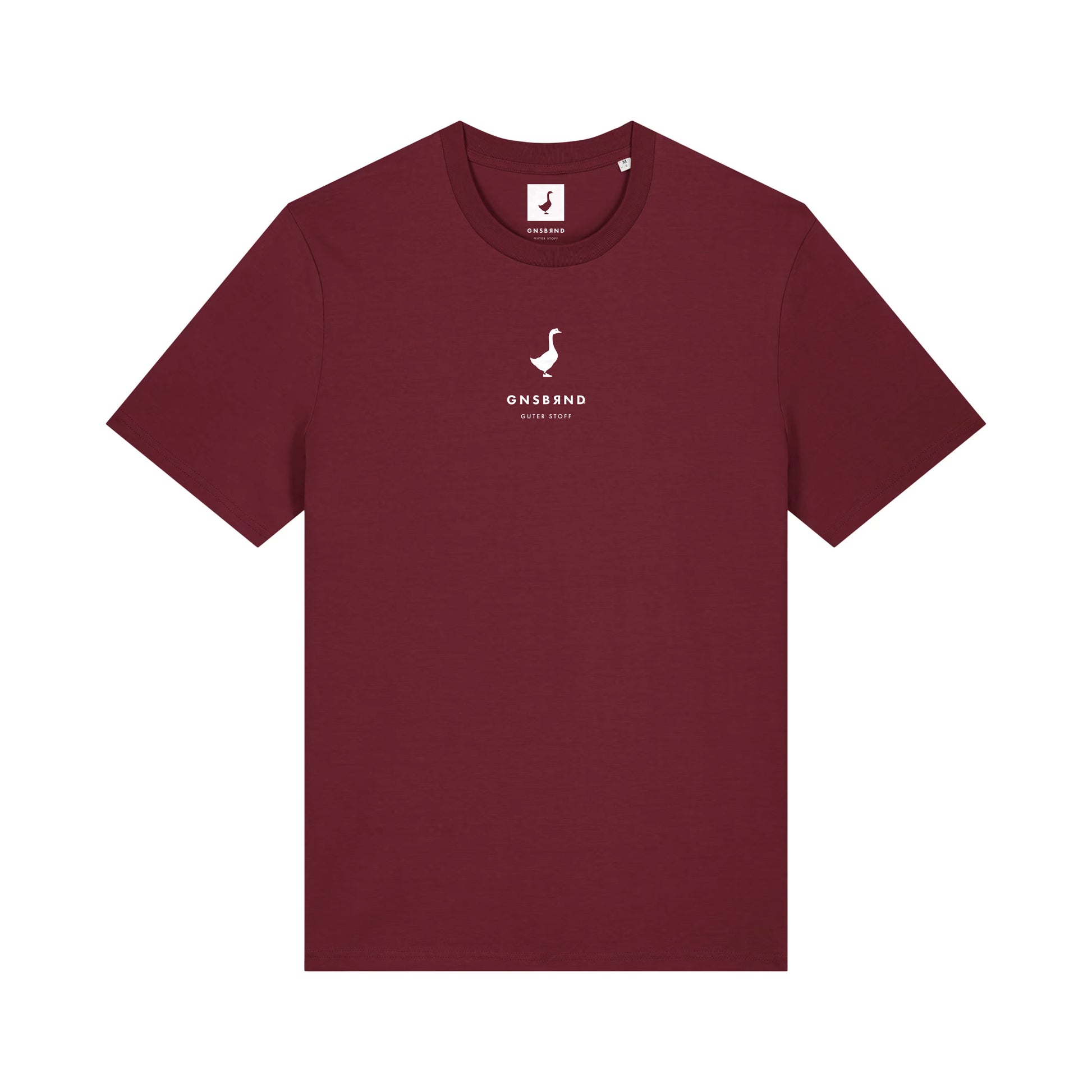 Das Liebesdorf Shirt von GNSBRND ist ein schlichtes kastanienbraunes Unisex-T-Shirt aus Bio-Baumwolle. Es hat kurze Ärmel und ein kleines weißes Logo mit "GNSSAND SINCE 2019" mittig auf der Brust.