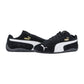 Die Puma Speedcat OG Sneakers in Schwarz haben weiße Seitenstreifen, goldenes Puma Branding und schwarze Gummisohlen. Der eine steht aufrecht, während der andere zur Seite kippt und so seinen authentischen Racing-Lifestyle-Appeal unterstreicht.