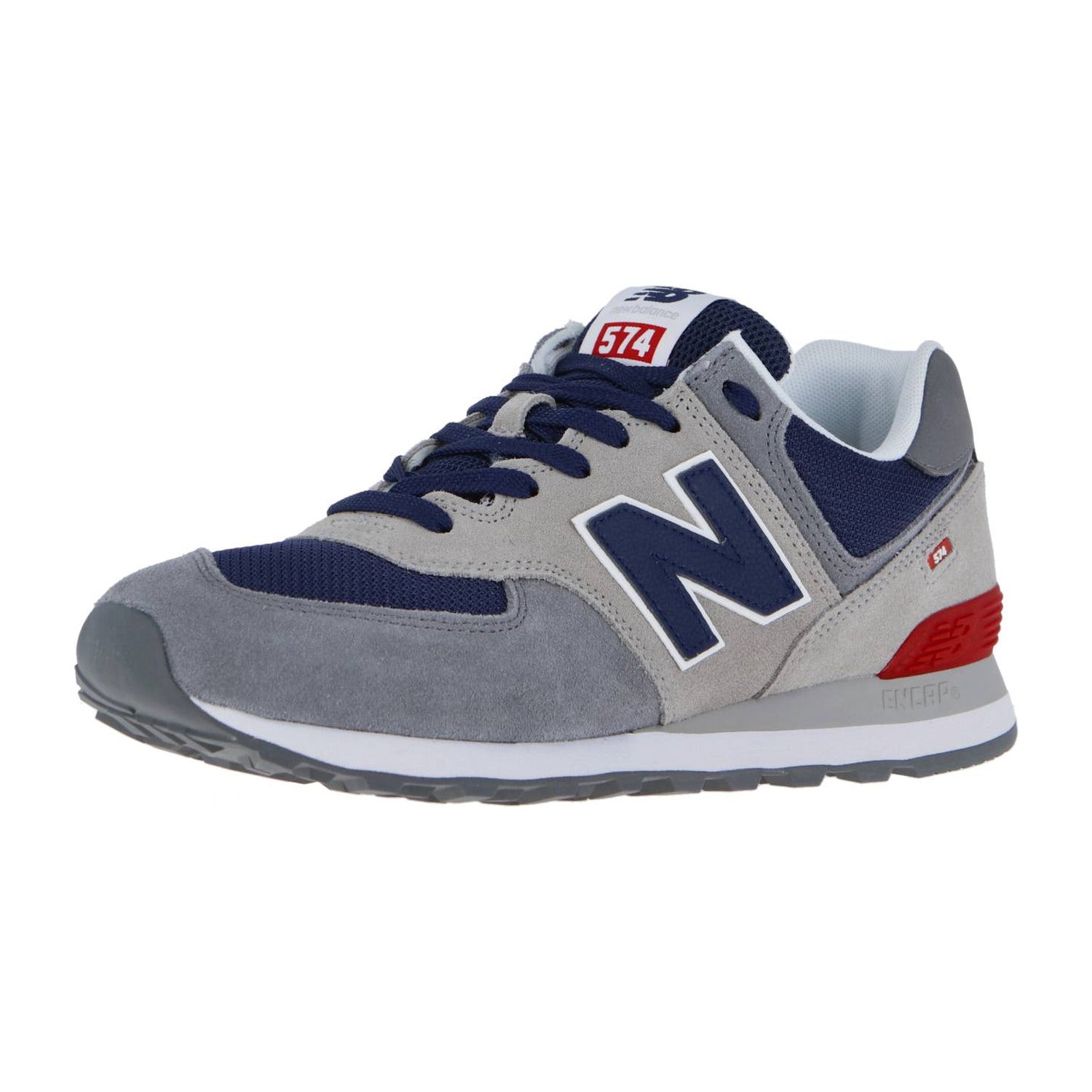 Der New Balance 574 V2 verfügt über graue Wildleder-Overlays, Mesh-Einsätze, rote Akzente, ein auffälliges N-Logo, die charakteristische ENCAP-Dämpfung für Komfort und eine stylische graue Außensohle in einer grauen, marineblauen und weißen Farbkombination.