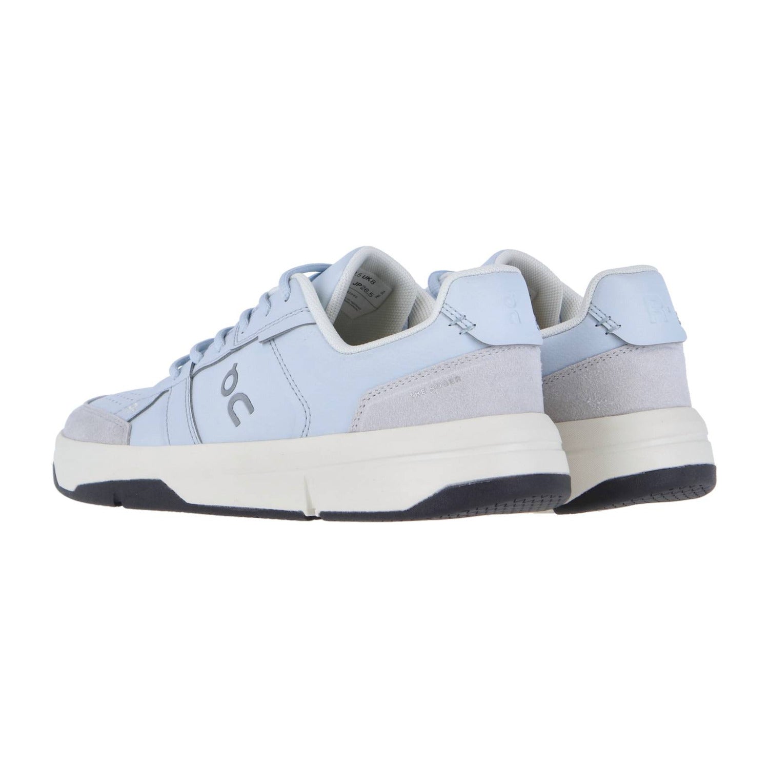 Ein Paar hellblaue THE ROGER CLUBHOUSE Sneakers von On, mit weißer Zwischensohle, schwarzer Laufsohle und "veganem Leder", von hinten und von der Seite gezeigt. Die Low-Top-Schuhe haben ein dezentes Branding an der Seite und an der Ferse.